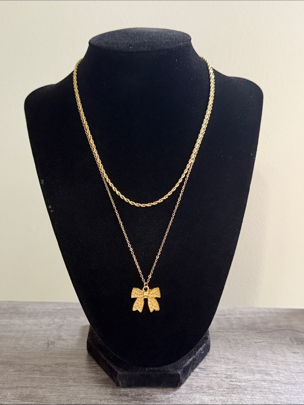 Layered rope chain necklace with bow pendant